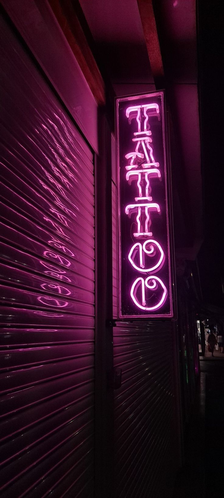 a neon sign that is on the side of a building