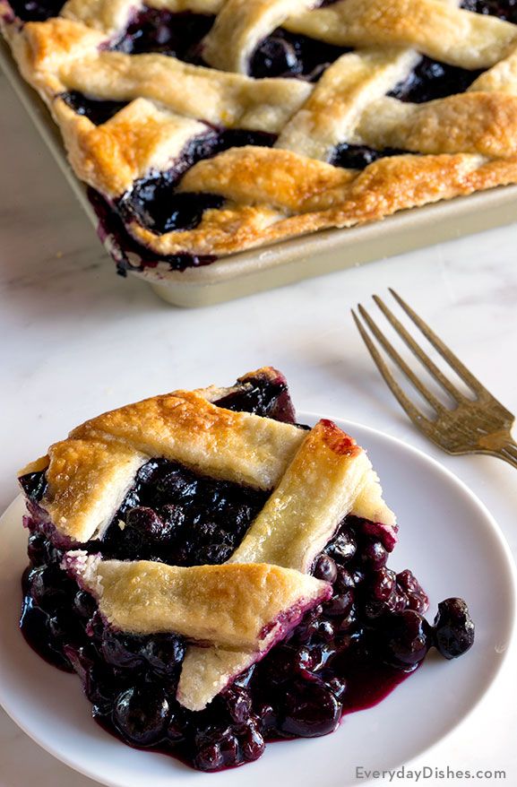 a blueberry pie on a plate with a fork