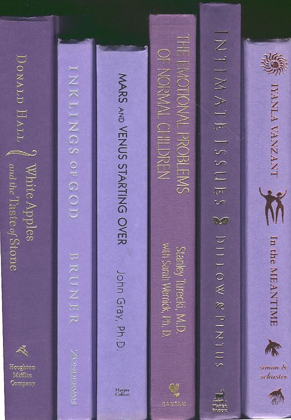 a row of purple books sitting on top of each other