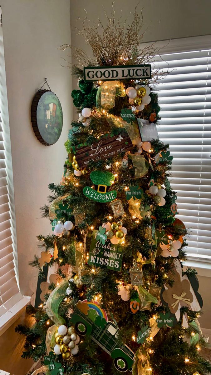 a christmas tree decorated with green and gold ornaments