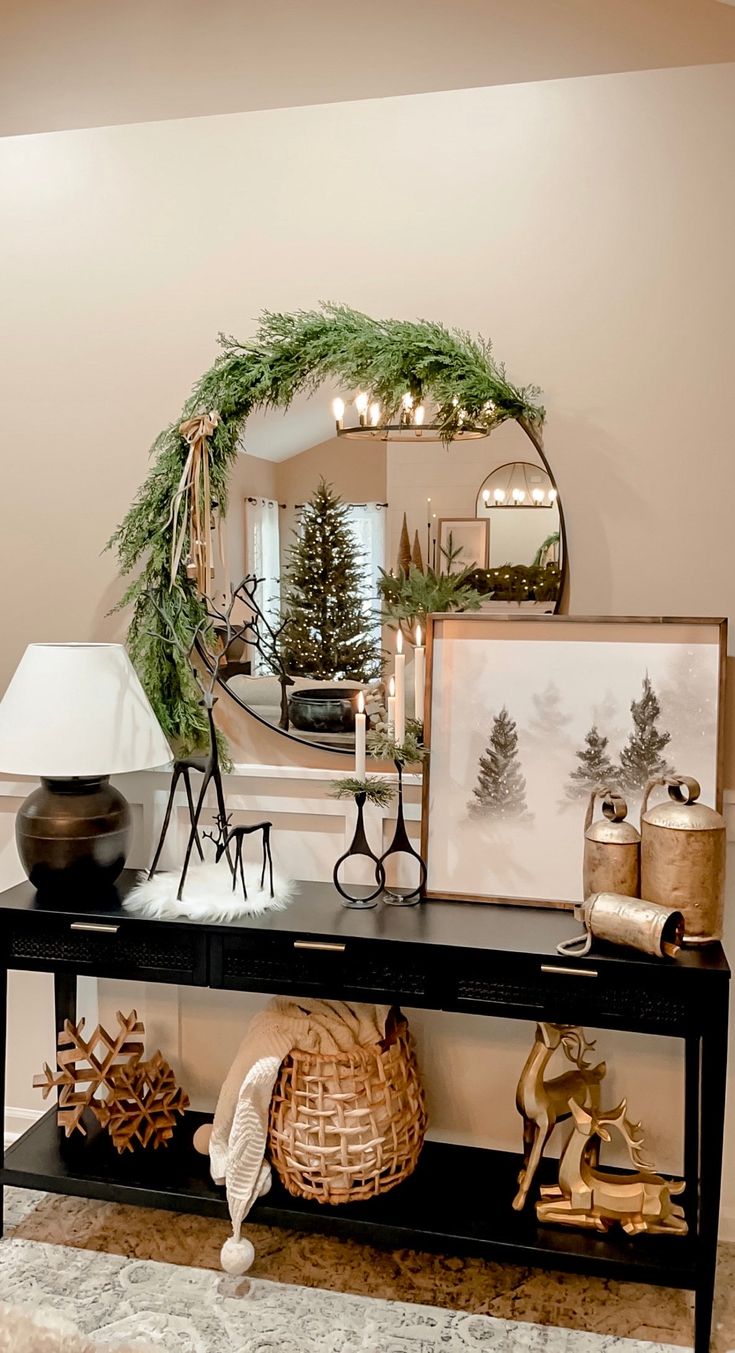 a table with christmas decorations on it in front of a mirror and other decor items