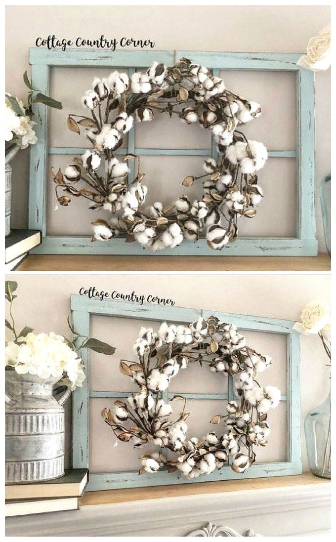 two frames with flowers and cotton in them on top of a shelf next to an old window