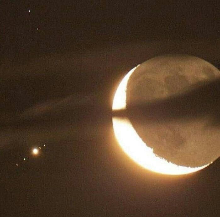 the moon is seen in front of an object that appears to be half - moon