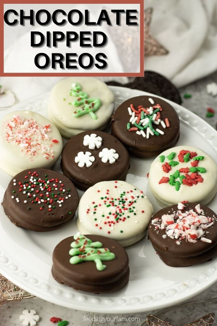 chocolate dipped oreos on a white plate with sprinkles and christmas decorations