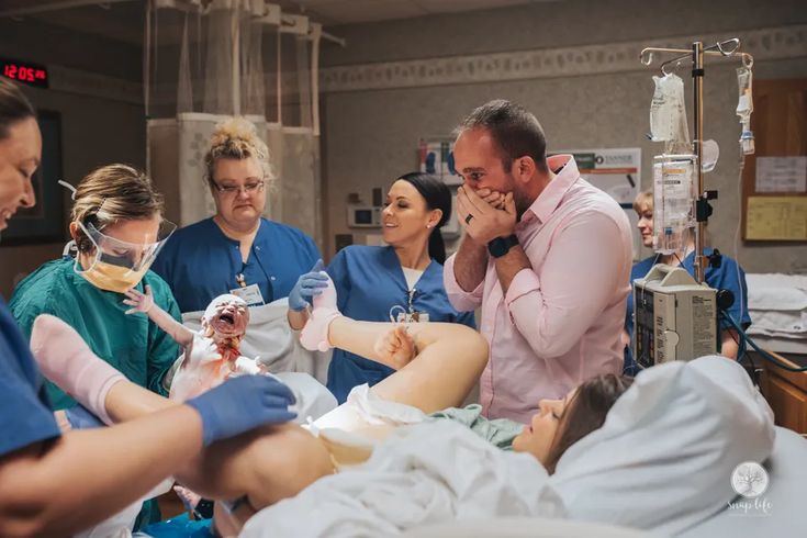 a group of people in scrubs around a patient