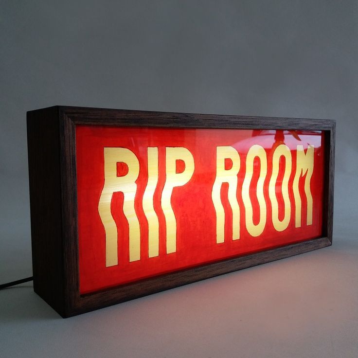 a red and yellow sign that says rip room in gold lettering on the side of it