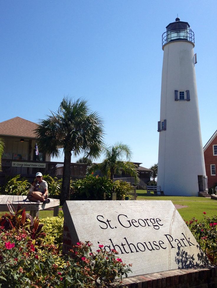 a sign that is in front of a light house