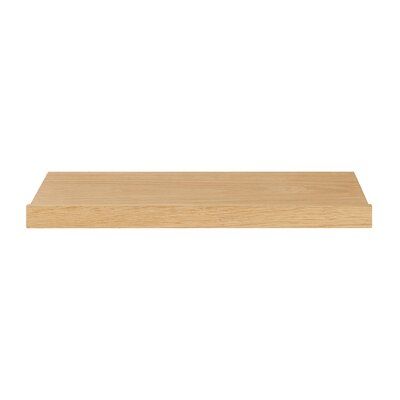 a wooden shelf that is on top of a white wall