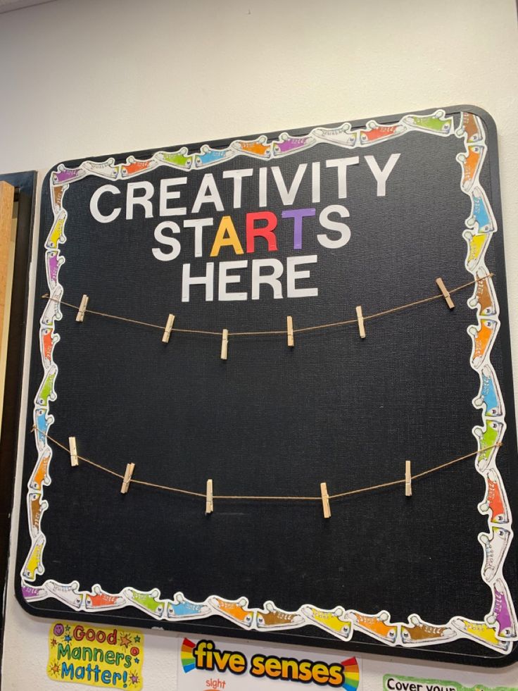 a bulletin board with clothes pins attached to it and the words creativity starts here written on it