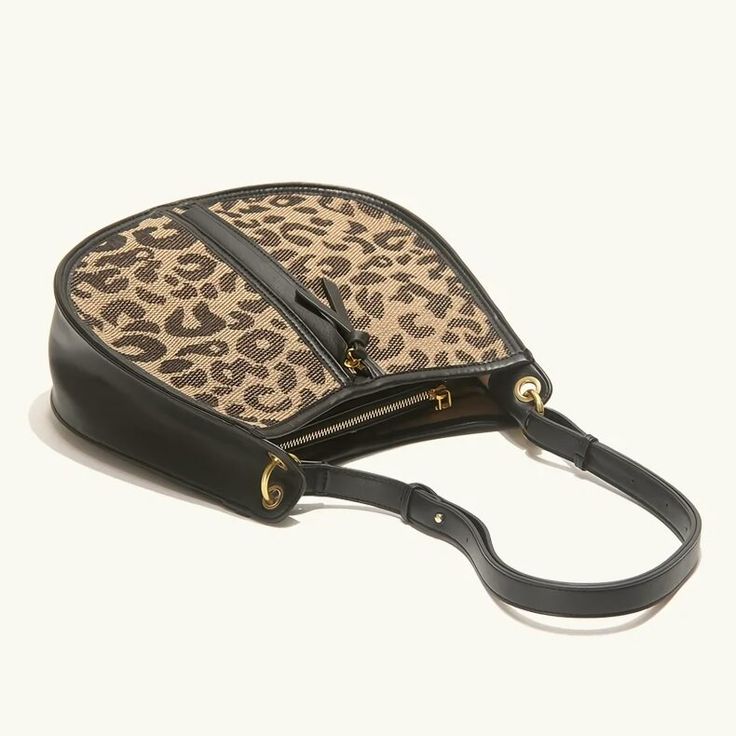 Upgrade Your Style with the Leopard Saddle Shoulder Bag Elevate your fashion game with our Leopard Saddle Shoulder Bag, crafted from premium microfiber leather for a luxurious feel. Designed for the modern woman, this bag combines functionality with trend-setting style, making it the perfect accessory for any occasion. Product Features Microfiber leather upper for durability and a sleek look Polyester lining material for added strength and resilience Zipper closure for secure storage of your essentials Bow decoration adds a touch of charm and femininity Spacious interior with an interior slot pocket for easy organization Available in classic Black or versatile Brown Benefits You'll Love Elevated Style: Stand out from the crowd with the chic leopard print design and sleek saddle shape of th Trendy Satchel Saddle Bag With Detachable Handle, Trendy Saddle Bag With Detachable Handle And Satchel Shape, Trendy Saddle Bag With Detachable Handle For Everyday Use, Trendy Everyday Saddle Bag With Detachable Handle, Handheld Saddle Bag For Everyday Use, Trendy Leather Hobo Bag With Zipper Closure, Trendy Leather Saddle Bag With Detachable Handle, Trendy Saddle Bag With Detachable Handle, Trendy Faux Leather Hobo Bag With Detachable Strap