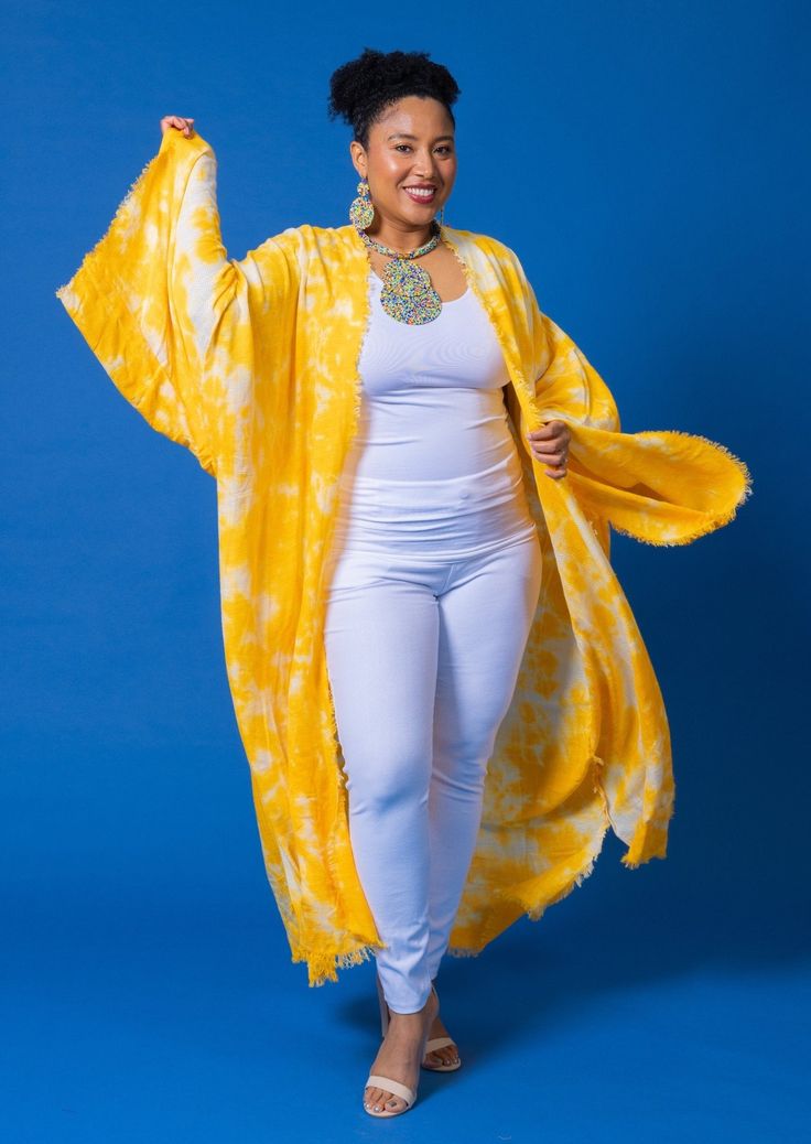 Experience the vibrant energy of summer with our Yellow Tie Dye kimono! Made with breathable fabric, this one-size-fits-most piece is perfect for any occasion. Versatile and comfortable, it's your go-to for effortless style all season long. Long Kimono For Fall Vacation, Long Fall Kimono For Vacation, Long Sleeve Kimono For Vacation, Long Cover-up For Spring Festivals, Summer Long Sleeve Kimono, Summer Long Sleeve One Size Kimono, Flowy Kimono For Fall Vacation, Flowy Fall Kimono For Vacation, Fall Vacation Kaftan With Kimono Sleeves