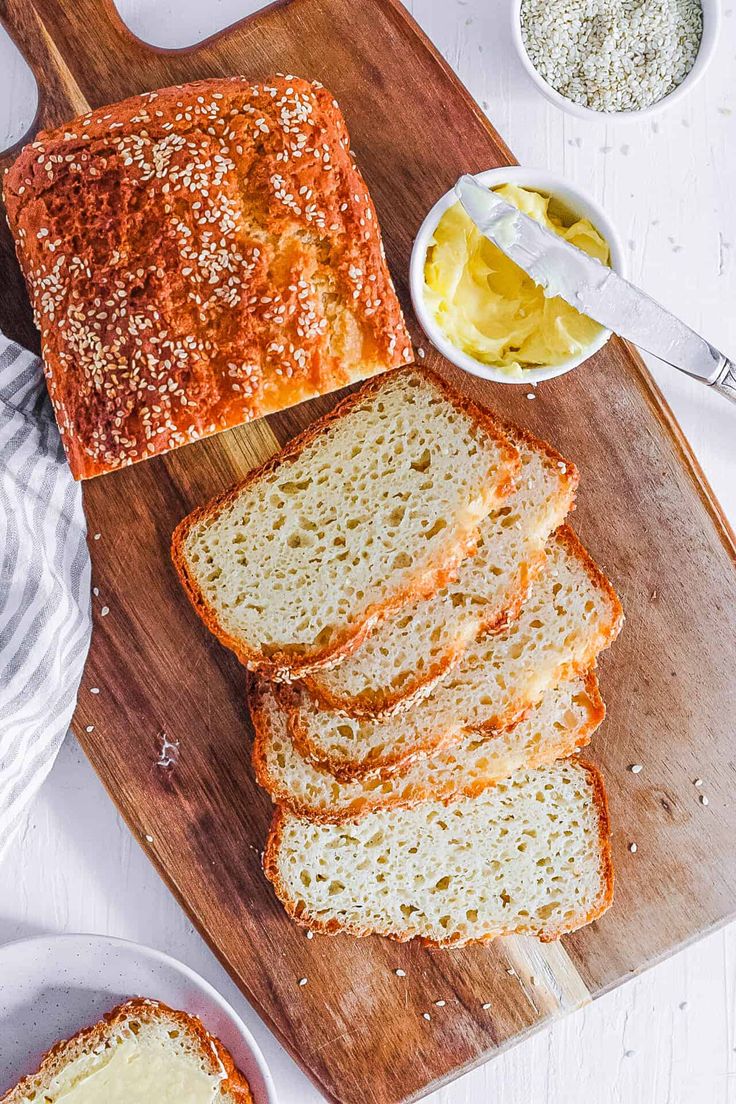 slices of bread sitting on top of a wooden cutting board