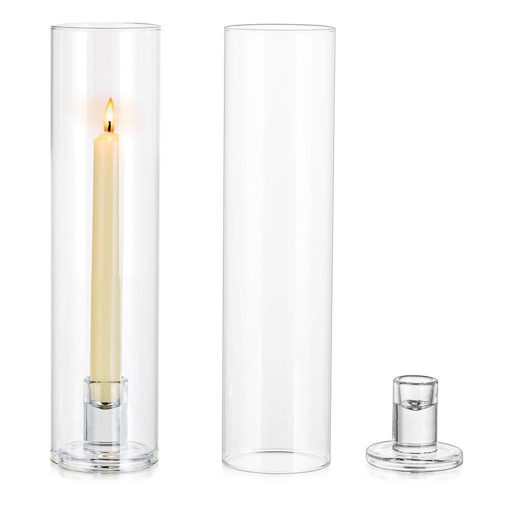 a tall glass candle holder with a lit candle in the middle and a smaller one next to it