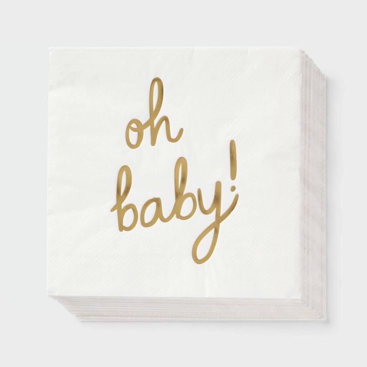 a white napkin with gold foil on it that says oh baby in cursive writing