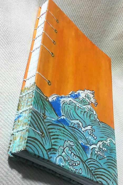 an orange and blue book with waves on it