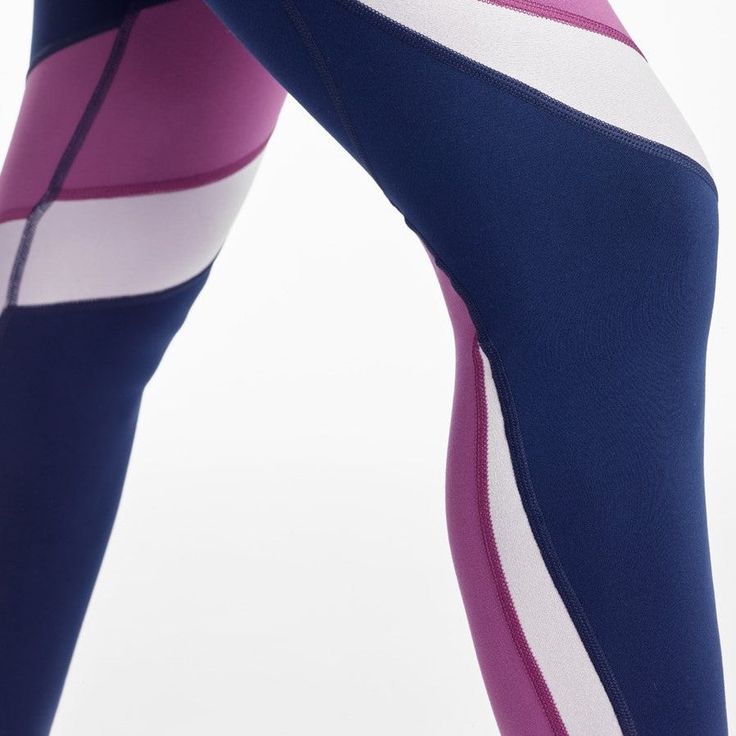 LEGGINGS by DYI CLOTHING These color-block leggings by DYI have contrasting panels wrapped around the leg to give it a unique color and a flattering look. It is made with a soft performance fabric, making it perfect for all activities by keeping you cool and dry with its quick drying and moisture-wicking features. You can pair these tights with their matching High Neck Elevate Racer Bras to complete the look! Performance Bionic fabric with the same fit as the DYI Signature Tight. Size Chart SIZE Sporty Color Block High Stretch Bottoms, Fitted Activewear With Contrast Stripes For Workout, Purple High Stretch Sporty Leggings, Color Block Athleisure Bottoms For Yoga, Athleisure Color Block Yoga Bottoms, Purple Sporty Leggings For Pilates, Sporty Purple Leggings For Pilates, Sporty Purple Tights For Pilates, Compression Color Block Gym Bottoms