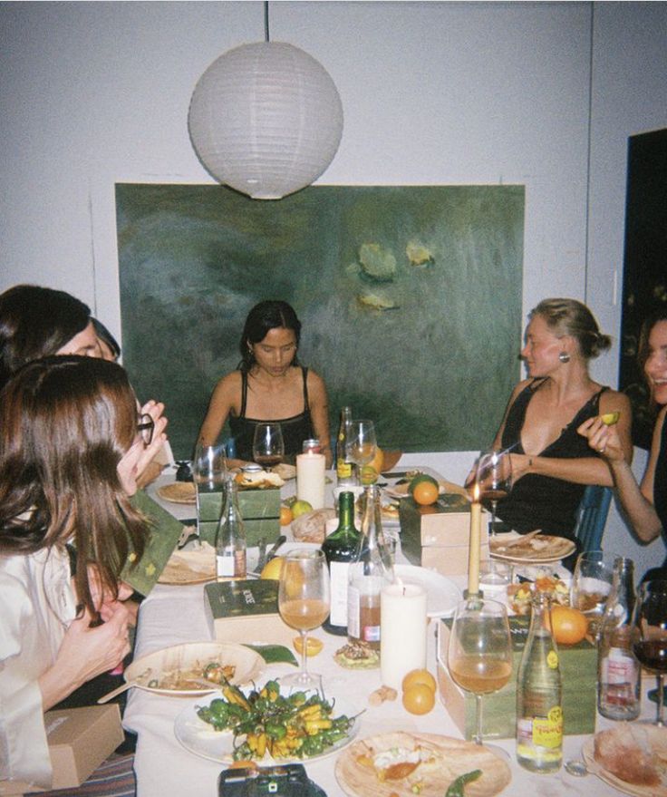 a group of women sitting around a dinner table