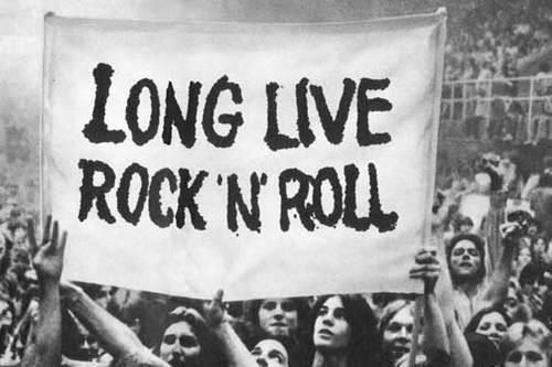 a group of people holding up a sign that says long live rock'n'roll