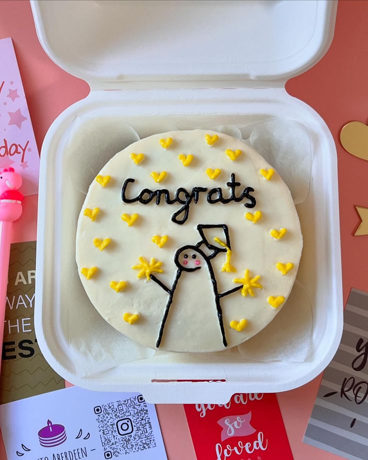 a cake in a box with congratulations written on it