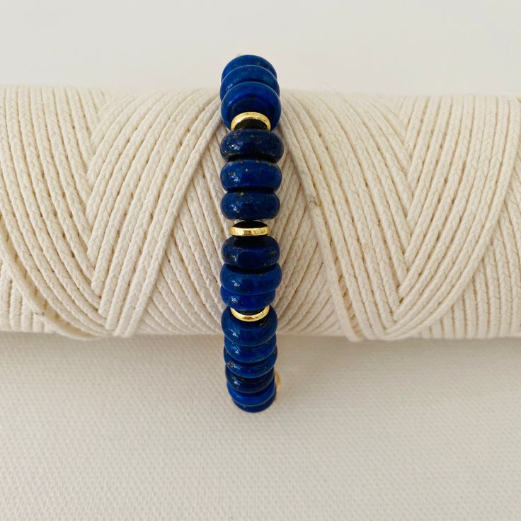 This is two looks in one bracelet. Half of the bracelet is beaded with gold and lapis beads and the other half is a chunky bold gold chain. It measures 18 inches in length and can be adjusted to a smaller size. Please note that the white bracelet shown in some of the photos is not included but can be purchased under Nico-White Gold Lapis Lazuli Beaded Bracelets With Round Beads, Everyday Blue Lapis Lazuli Beaded Bracelets, Hand-strung Gold Lapis Lazuli Bracelets, Gold Beaded Lapis Lazuli Bracelets, Everyday Blue Bracelets With Gold Beads, Handmade Gold Beaded Lapis Lazuli Bracelets, Adjustable Lapis Lazuli Beaded Bracelets For Everyday, White Bracelet, The Other Half