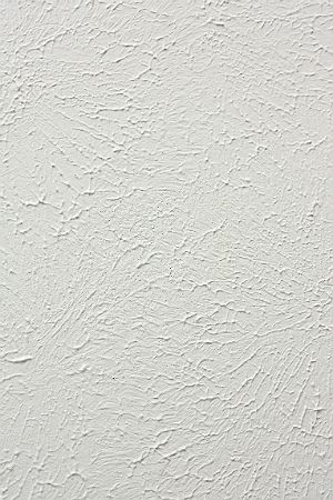 a white wall that has been painted with some kind of textured paint on it