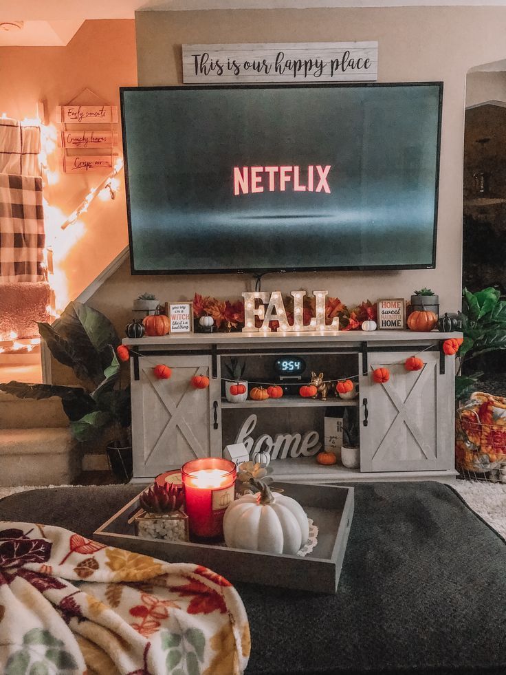 a living room filled with furniture and a flat screen tv on top of a wall