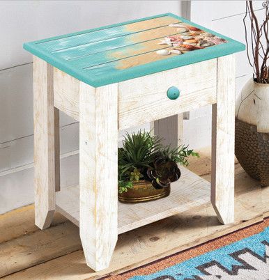 a small wooden table sitting on top of a rug next to a potted plant