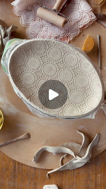 a bowl that is sitting on top of a table next to some scissors and other crafting supplies