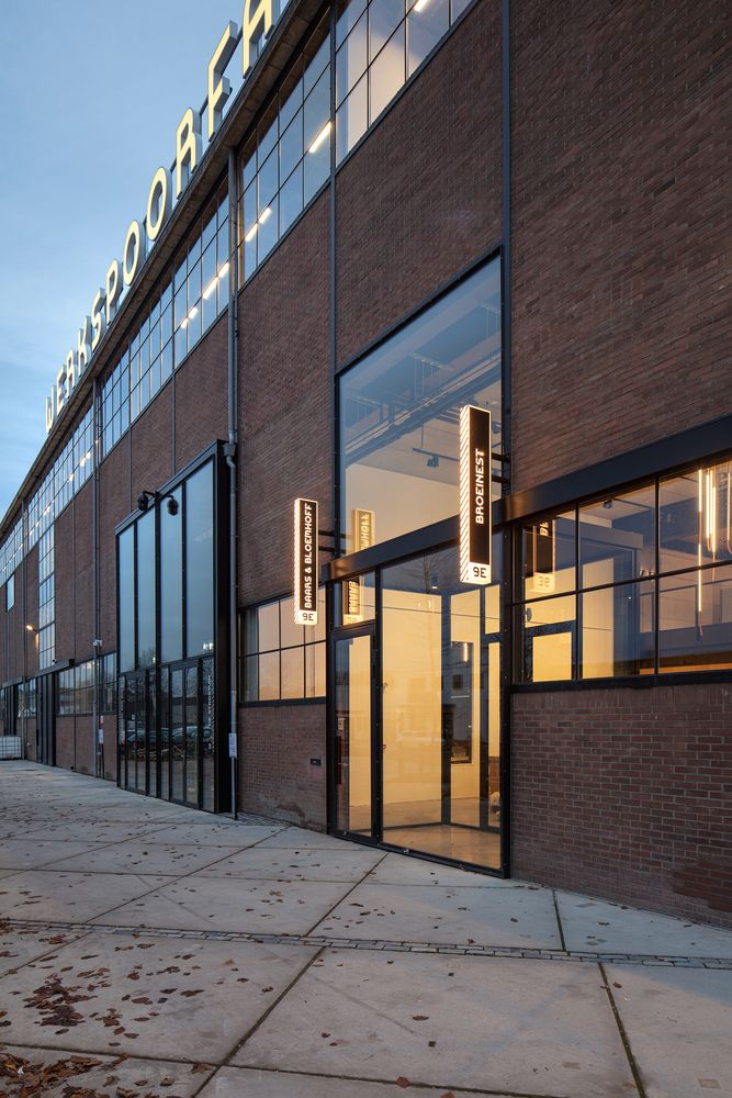 the entrance to an industrial building with large windows