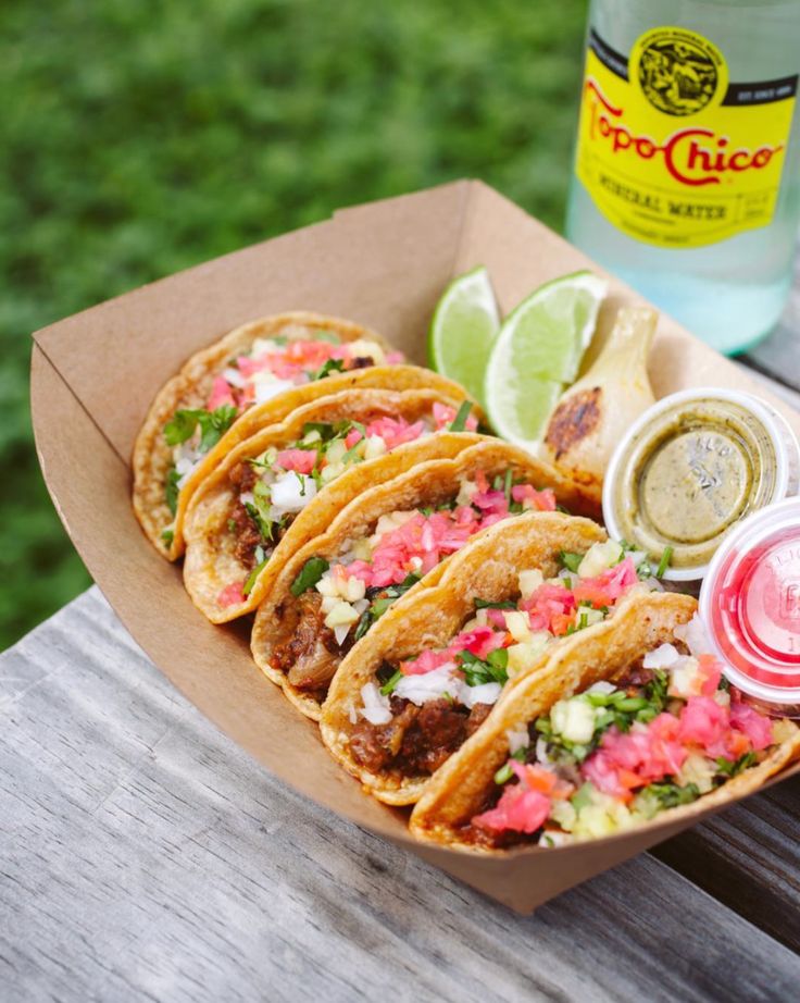 some tacos are sitting on a picnic table