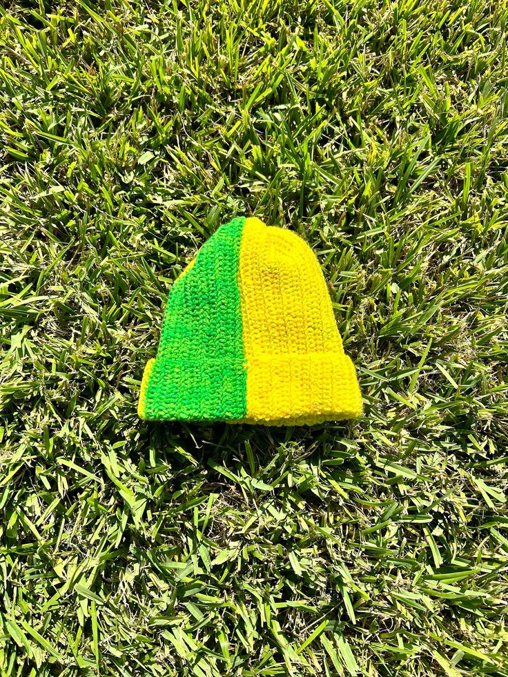 This is a hand made crochet beanie that I made myself with rainbow colored, color-changing yarn. This section of the yarn transitions from yellow to green within the project. Handmade Yellow Crochet Hat For Winter, Yellow Yarn Crochet Cap, Yellow Crochet Yarn Cap, Yellow Crochet Cap Hat, Handmade Yellow Crochet Hat, Green One Size Beanie, Yellow Yarn Crochet Hat, Yellow Hand Knitted Beanie Crochet Hat, Yellow Yarn Hat One Size