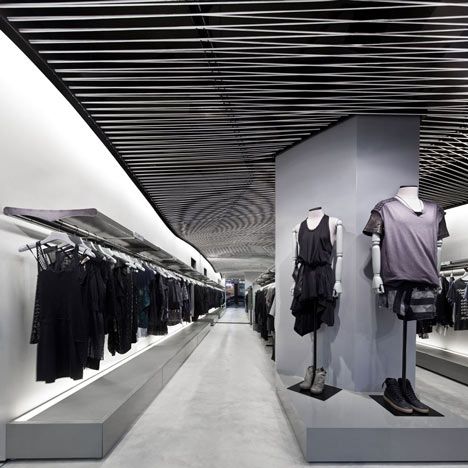 the inside of a clothing store with clothes on display