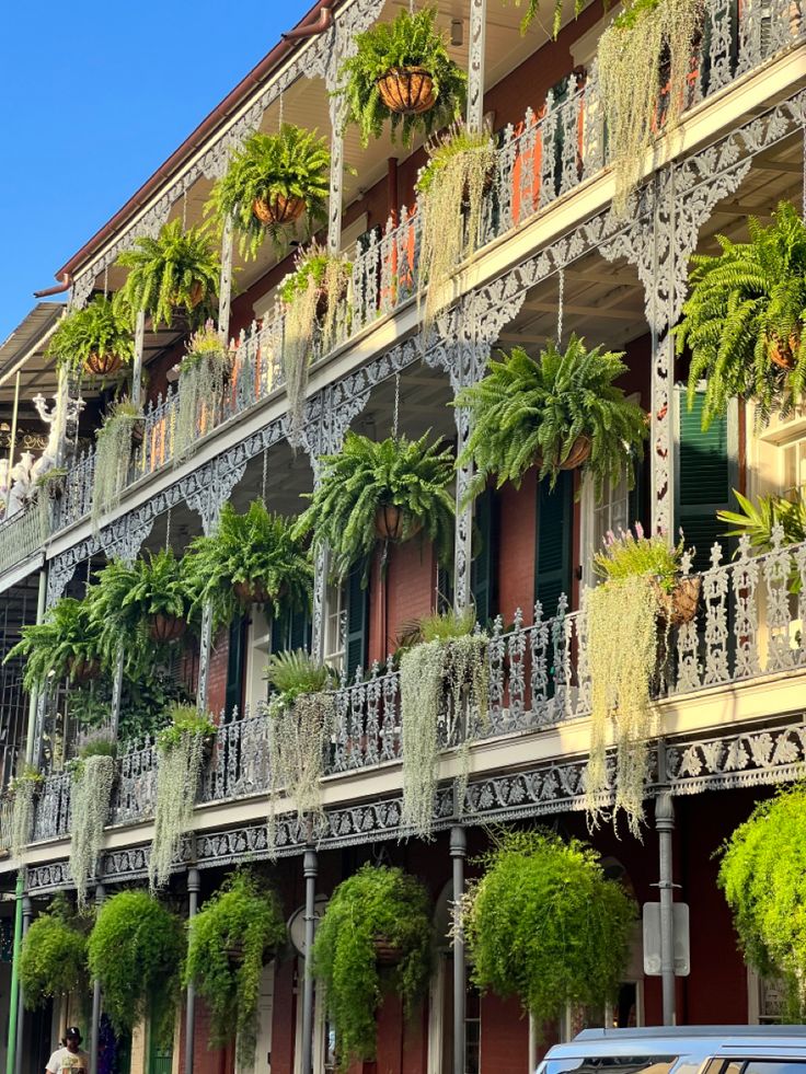 an old building with many balconies and plants on it