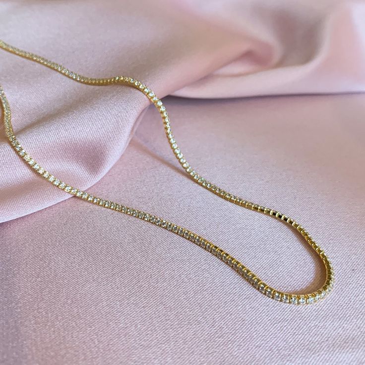 925 gold vermeil - Hypoallergenic - Lead + Nickel free 2mm Gold vermeil AAA cubic zirconia tennis chain choker. Measures: 13 inches with 4 inch extender. Doubles as a wrap bracelet! Can be worn as a choker or as a shorter chain up to 16 inches. Free shipping on all U.S orders. Gold Cubic Zirconia Tennis Necklace Gift, Elegant Gold Tennis Necklace Choker, Gold Tennis Necklace With Rhinestones For Gift, Gold Tennis Necklace With Rhinestones As A Gift, Cubic Zirconia Tennis Necklace With Adjustable Chain As Gift, Gold Plated Tennis Necklace - Perfect Gift, Minimalist Cubic Zirconia Tennis Necklace As Gift, Gold Clavicle Chain Tennis Necklace For Gift, Cubic Zirconia Tennis Choker Necklace