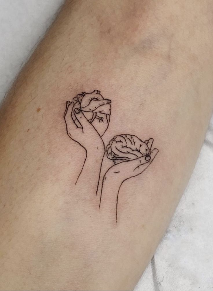 a person with a tattoo on their arm holding a piece of fruit