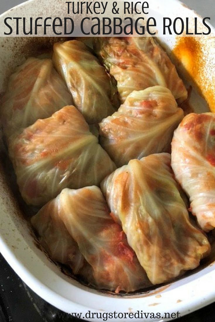 stuffed cabbage rolls in a white casserole dish