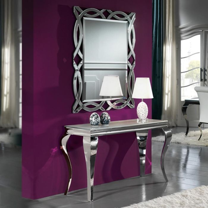 a living room with purple walls and a silver table in front of a white chair