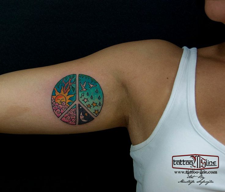 a woman with a peace sign tattoo on her arm