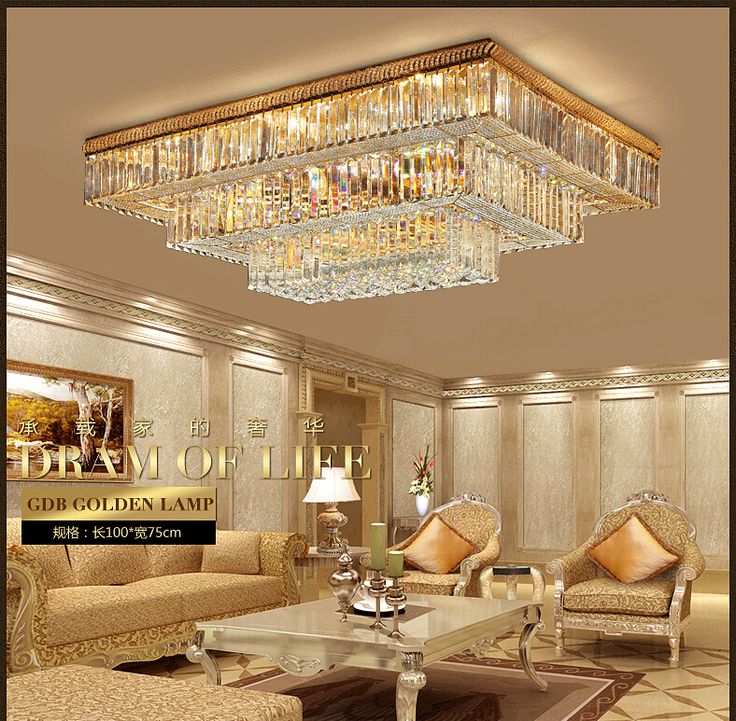 an elegant living room with chandelier and couches