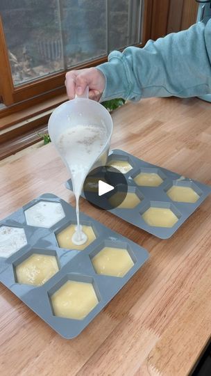 a person pouring batter into some cupcakes