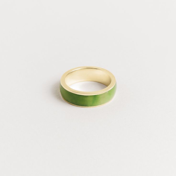 Introducing our 7mm men's inlay band, crafted with the finest green jade. This exquisite ring is a testament to the natural beauty of the stone and the stunning shades of green that jade is known for. We take great pride in sourcing our jade directly from the family that mines it, ensuring that every piece is of the highest quality and ethically sourced. The green jade is expertly cut and polished, then set into the band with precision and care. Our 7mm width is our most popular option, providin Jade Wedding Rings For Men, Modern Green Ring For Promise, Modern Green Promise Ring, Formal Green Enamel Ring With Polished Finish, Green Enamel Ring With Polished Finish As Gift, Silver Jade Ring, Modern Green Emerald Ring With Polished Finish, Minimalist Green Emerald Ring With Polished Finish, Green Enamel Ring With Polished Finish For Anniversary