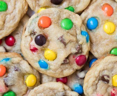 a white plate topped with cookies covered in m and m candies on top of it