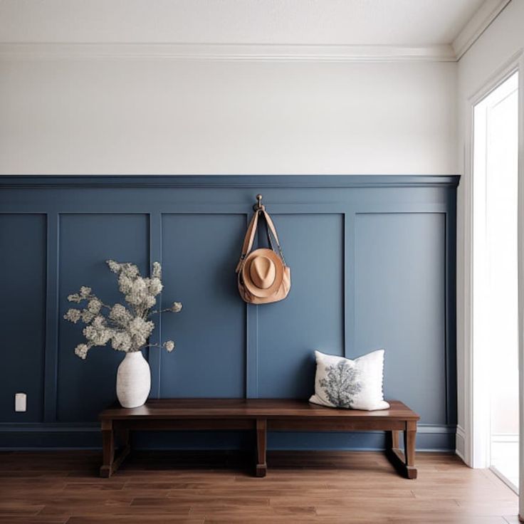 a wooden bench sitting in front of a blue wall