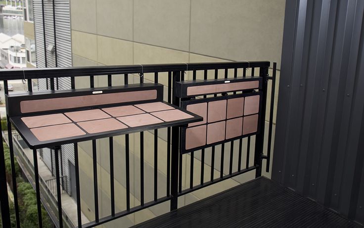 two metal railings with pink tiles on them