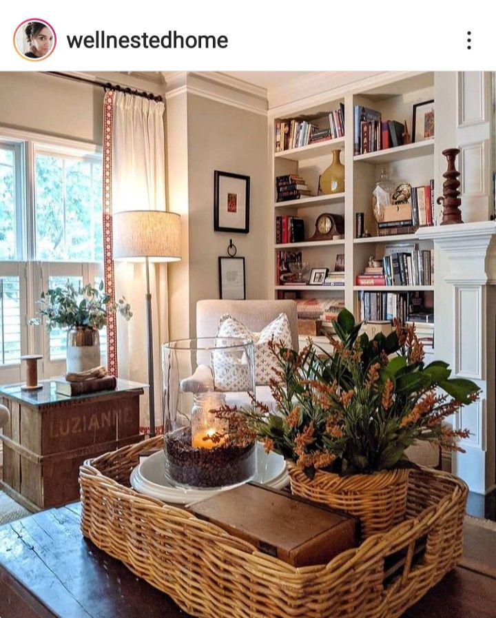 a living room filled with furniture and a fire place next to a book shelf on top of a hard wood floor