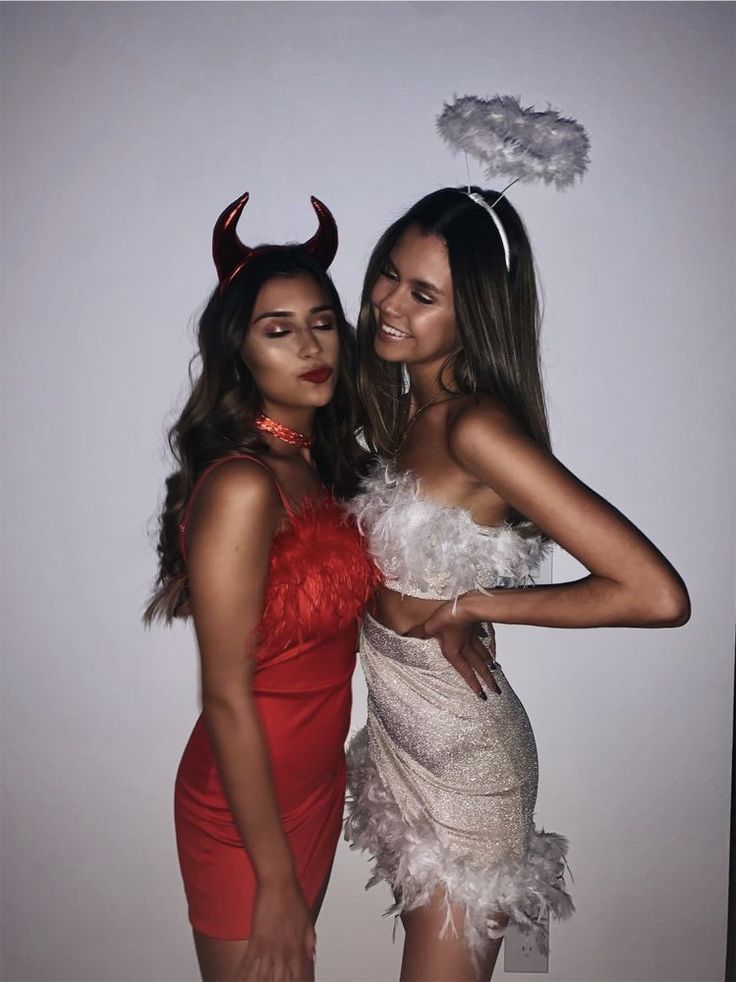 two women dressed up in costumes posing for the camera