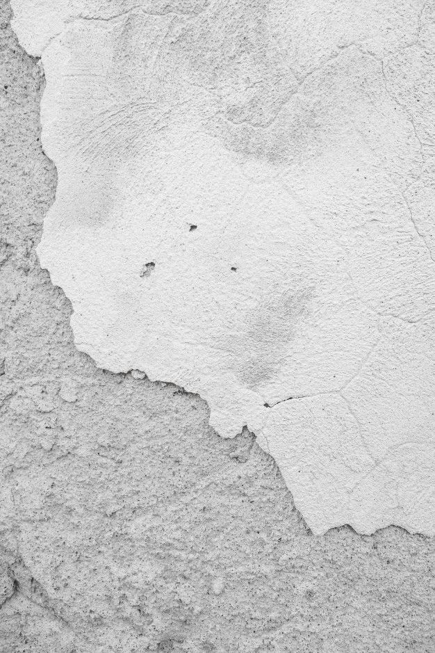 a black and white photo of the surface of a cement wall with cracks in it