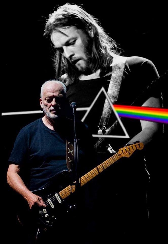 a man holding a guitar in front of a rainbow light