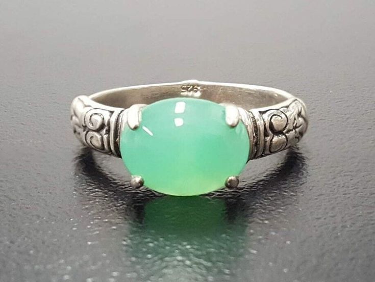 Chrysoprase Boho Ring set with a Natural Chrysoprase in a cabochon cut & vivid green color, at size 10x8mm (3 Cts) from Australia.Solid 925 Sterling Silver ☞ made to last.Click here for ☞ Boho CollectionDetails:• Natural Chrysoprase sourced from Australia• Chrysoprase: 10x8mm, 3 Cts, cabochon cut• Dimensions: Band width ≈ 2.7mm, thickness ≈ 1.2mm• Solid 925 Sterling Silver❀ Each Natural Gem is unique & will have Slight variations from the product pictures "no two Natural Stones are alike" SKU 28 Handmade Green Chrysoprase Ring, Green Oval Chalcedony Rings, Oval Green Chalcedony Rings, Green Chalcedony Gemstone Rings, Green Oval Opal Ring In Sterling Silver, Green Oval Moonstone Gemstone Ring, Oval Green Moonstone Gemstone Ring, Green Oval Moonstone Ring, Handmade Green Chalcedony Rings