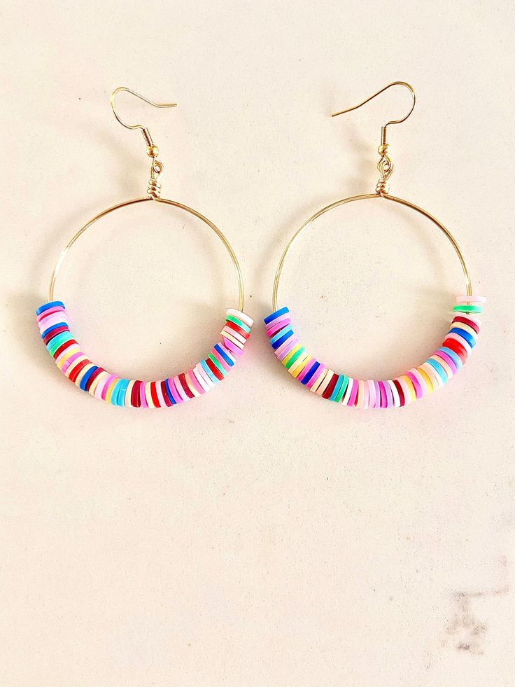 Playful Heishi beaded hoop earrings. These super fun, lightweight hoops are sure to bring pizazz to any outfit!  Hoops can be made in silver or gold tarnish resistant wire. They can be made in small, medium, or large (pictured). Just specify size at checkout. Fun Round Heishi Beads Jewelry, Trendy Circular Earrings With Colorful Beads, Playful Round Jewelry With Colorful Beads, Playful Jewelry With Colorful Beads, Playful Round Beaded Jewelry, Playful Colorful Beads Jewelry, Playful Multicolor Hoop Jewelry, Adjustable Heishi Beads Earrings With Ear Wire, Adjustable Hoop Earrings With Dangling Beads